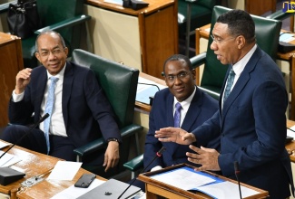 Prime Minister, the Most Hon. Andrew Holness, makes a statement during the Sitting of the House of Representatives on Tuesday (June 27). Listening (from left) are the Minister of National Security, Hon. Dr. Horace Chang and Minister of Finance and the Public Service, Dr. the Hon. Nigel Clarke.