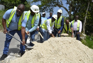 Minister without Portfolio in the Ministry of Economic Growth and Job Creation with responsibility for Works, Hon. Everald Warmington (fourth left), breaks ground for the commencement of the Darliston to Withorn road rehabilitation project in Westmoreland, in Darliston on July 6. Also participating are (from left) Managing Director of Morris Hill Ltd., Kelvin Hill; Member of Parliament for Westmoreland Eastern, Daniel Lawrence; Member of Parliament for Westmoreland Western, Moreland Wilson; Member of Parliament for Westmoreland Central, George Wright; Regional Manager for the National Works Agency (NWA) – Western Region - Robert Francis and Councillor Caretaker for the Darliston Division, Godfrey Walters.