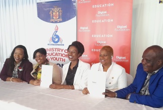 Acting Chief Education Officer, Dr. Kasan Troupe (left), participates in the signing ceremony for the establishment of a Smart Room at Homestead Primary and Infant School in St. Catherine by the Digicel Foundation. The function was held recently at Terra Nova All-Suite Hotel in Kingston. The signatories (from second left) are Regional Director in the Ministry of Education and Youth, Sophia Forbes Hall; Senior Operations Manager at the Digicel Foundation, Jodi-Ann McFarlane; Principal of Homestead Primary and Infant Sophia Deer, and Chairman of the school board, Mark McLean.