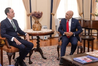 Governor-General, His Excellency the Most Hon. Sir Patrick Allen (right), converses with outgoing Ambassador of Belgium to Jamaica, His Excellency Hugo Verbist, during the diplomat’s farewell courtesy call at King’s House on Thursday (July 13).
