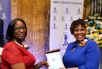 President of the Jamaica Teachers’ Association (JTA), La Sonja Harrison (right), presents Christine Josephs of Vauxhall High School with the JTA’s Golden Torch Award for 43 years of service to education, at The Jamaica Pegasus hotel in New Kingston on Tuesday (July 11). Two hundred and six teachers were recognised for giving a minimum of 35 years of service to education.