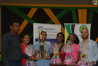 St James Social Development Commission (SDC) Parish Manager, Randy Hayle (left), joins the Farm Heights quiz team as members show off their first place trophy and prizes, following the Social Development Commission (SDC) ‘Reach the Youth’ Quiz Competition, held at the Montego Bay Civic Centre in Sam Sharpe Square, St. James, on Wednesday, August 16. They are (from second left): Aniska Christie, Brianna Miller, Donovan McKenzie, Adria McKenzie and Nashu Lelievre.