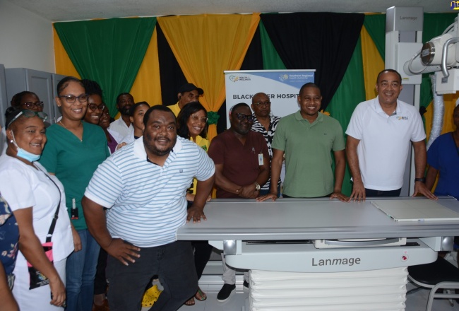 Minister of Health and Wellness, Dr. the Hon. Christopher Tufton (second right) and Minister of Agriculture, Fisheries and Mining, Hon. Floyd Green (third right), with staff of the Black River Hospital in St. Elizabeth, at the handover of the $37 million digital retrofit system at the institution on Friday (July 28).