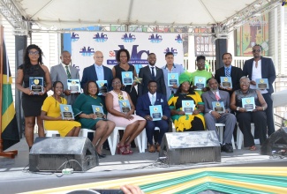 Deputy Mayor of Montego Bay, Councillor Richard Vernon (centre, standing), with recipients of the Spirit of Independence awards during the St. James Independence Day Civic Ceremony at Sam Sharpe Square in Montego Bay on Sunday (August 6).