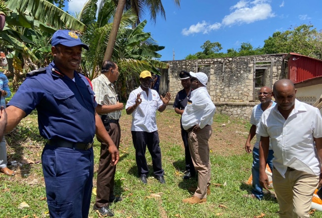 Minister of Local Government and Community Development, Hon. Desmond McKenzie (third left), engages stakeholders from the St. Elizabeth Municipal Corporation and Jamaica Fire Brigade as they tour one of the proposed sites for the construction of a new fire station in the Balaclava area of St. Elizabeth, on Wednesday, June 21.