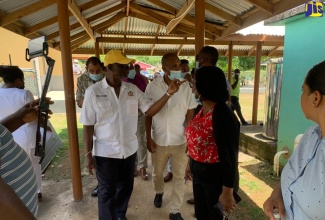 Minister of Local Government and Community Development, Hon. Desmond McKenzie, leads a tour of the St. Elizabeth Infirmary in Santa Cruz, on Wednesday, June 21.