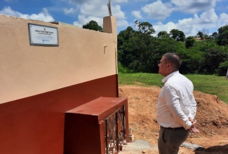 Minister without Portfolio in the Ministry of Economic Growth & Job Creation, Senator the Hon. Matthew Samuda, inspects the new 20,000-gallon tank erected at the Albert Town High School in Trelawny, on Thursday, June 29. With the Minister is Acting Principal of Albert Town High School, Janice Skeen-Miller.