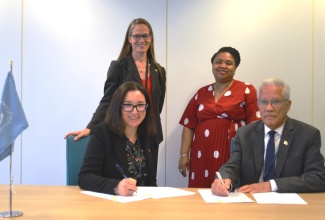 Director General of the Maritime Authority of Jamaica, Rear Admiral (retd.) Peter Brady and Director General, Marine Safety and Security at Transport Canada, Joanna Manger, sign a Reciprocal Recognition Agreement to enable seafarers from Jamaica and Canada to work on ships sailing under the Jamaican or Canadian flags, at the International Maritime Organization Headquarters, in London, recently.  Witnessing the signing are Alternate Permanent Representative to the International Maritime Organization, Michelle Toering Sanders (left, standing) and Acting Jamaican High Commissioner to the United Kingdom, Patrice Laird Grant.  