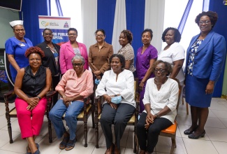 Chief Nursing Officer in the Ministry of Health and Wellness, Patricia Ingram Martin (left, back row), and Chief Medical Officer (CMO), Dr. Jacquiline Bisasor-McKenzie (fourth left, back row), with staff at the Kingston Public Hospital (KPH) and retired Jamaican overseas nurses who are working on the CODE CARE programme, during a recent visit to the KPH, in Kingston.