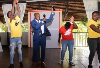 Minister of Labour and Social Security, Hon. Pearnel Charles Jr., dances along with student leaders at the 2023 Juici Patties Youth Leadership Workshop and Volunteer Programme held at The Verandah, Juici’s Empowerment Park, in Clarendon on Tuesday (July 11).