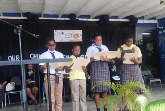 Student Leaders at the Morant Bay Primary School in St. Thomas read the proclamation on the National Day of Mourning for Jamaica’s Children, which was observed in a special devotional exercise at the school today (June 23).