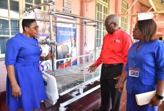 Chairman of the South East Regional Health Authority (SERHA), Wentworth Charles (centre), in discussion with Director of Nursing at the Spanish Town Hospital, Novellette Robinson (left) and Director of Nursing Services at the Bustamante Hospital for Children (BHC) in St. Andrew, Beverley Senior Berry, during the recent handover of beds to the two hospitals, held at the BHC.