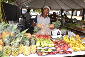 Farmer, Jennifer Mais, displays her produce during the Emancipation Day event, ‘Augus’ Mawnin Market’, on Tuesday (August 1) at the National Arena in Kingston.