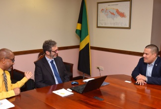 Minister without Portfolio in the Ministry of Economic Growth and Job Creation, Senator the Hon. Matthew Samuda (right), converses with (from left) Principal Director, Meteorological Service of Jamaica, Evan Thompson, and Météo-France Manager for Latin America and the Caribbean, Jean-Marc Terrisse, during a courtesy call at the Ministry’s offices in New Kingston on June 28. Météo-France is the French national meteorological service.