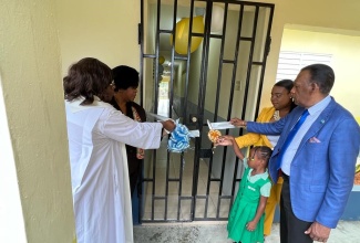 The ribbon is cut to open the new classroom block at the Savanna-la-Mar Infant School. Participating in the exercise (from left) are School Board Chair, Reverend Opal Beharie; Regional Four Director, Ministry of Education and Youth, Dr Michelle Pinnock; the School’s Principal, Praise Thompson-Brown; Student, Leana Barker and Chief Executive Officer, Culture, Health, Arts, Sports and Education (CHASE) Fund, Wilford “Billy” Heaven.