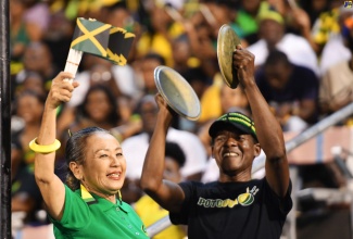 Terry Salmon (left) and Dalton Spence, celebrate Jamaica’s 61st Independence anniversary, during the Grand Gala at the National Stadium on August 6.