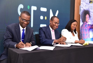 Minister of Finance and the Public Service, Dr. the Hon. Nigel Clarke (centre), along with President of The Mico University College, Dr. Asburn Pinnock (left), and Executive Director of the Students’ Loan Bureau (SLB), Nickeisha Walsh, sign a Memorandum of Understanding (MOU), for the execution of the $2.5-billion Science, Technology, Engineering and Mathematics (STEM) education scholarships, today (June 29), at the Courtyard by Marriott Hotel in New Kingston.