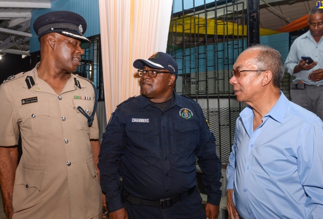 Minister of National Security, Hon. Dr. Horace Chang (right), in discussion with Assistant Commissioner of Police (ACP), Gary Griffiths (left) and Senior Superintendent of Police (SSP), Howard Chambers, at a meeting with businesspersons in Bog Walk, St. Catherine, on June 21