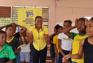 Acting Special Projects Manager, Jamaica Information Service (JIS), Charnele Henry (centre), joins children from the Sandy Park community in their rehearsal of the Jamaican folk song, ‘Linstead Market’ during the Teach the Youth Programme Culture Day activities at the Sandy Park New Testament Church of God in St. Andrew on Wednesday (July 19). For two weeks, children from the community gathered at the church, where they were engaged in academic and personal development activities under the summer programme, which is organised by the University of Technology (UTech) Students Union. The JIS is a sponsor of the initiative. Other beneficiary communities include Highlight View, Tavern, Kintyre, August Town and Hermitage.