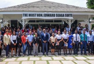 Minister of Tourism, Hon. Edmund Bartlett (centre), with tourism officials, representatives of companies and interns who participated in the 2023 Tourism Enhancement Fund (TEF) Summer Internship Programme following a media briefing on Thursday (August 17) at the Most Hon. Edward Seaga Suite, Devon House, St. Andrew.