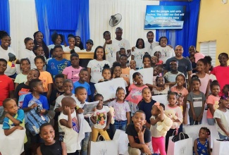 Children from Mount Moreland and surrounding communities in St. Catherine with their educational gifts at a back-to-school treat organised by the Tameka Hill Foundation on July 29, at the Mount Moreland Church of God of Prophecy.