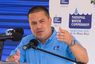 Minister without Portfolio in the Ministry of Economic Growth and Job Creation, Senator the Hon. Matthew Samuda, addresses the commissioning ceremony for water projects in Clarendon South Eastern on July 20.