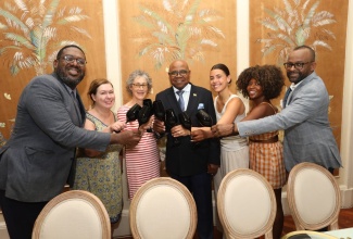 Minister of Tourism, Hon. Edmund Bartlett (centre) and Director of Tourism, Jamaica Tourist Board, Donovan White (right), with a group of international journalists at the ‘Come Back to Craving’ event, held at the Devon House Mansion in Kingston, on June 21.