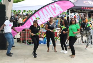 Jamaica Tourist Board (JTB) Business Development Officer for Northeast United States, Kirk Wright (left), and members of staff at the Jamaican Embassy in Washington DC (from second left), Melissa Baker, Makeda Reynolds, Attilah Beckford, and Georgette Smith, show off their dance moves at ‘Jamaica Fest’ at Veterans Plaza downtown Silver Spring, Maryland on September 17.