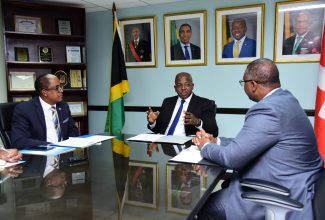 Minister of Labour and Social Security, Hon. Pearnel Charles Jr. ( centre), converses with Ambassador-designate of the Swiss Confederation, Dr. Richard Brown (right), during a meeting at the Ministry’s offices in downtown Kingston on September 5. Looking on is State Minister in the Ministry of Labour and Social Security, Dr. the Hon. Norman Dunn.