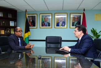 State Minister in the Ministry of Labour and Social Security, Dr. the Hon. Norman Dunn (left) is in conversation with Ambassador of the Republic of Cuba to Jamaica, His Excellency Fermin Quiñones Sánchez, during a courtesy call at the Ministry’s offices in downtown Kingston on September 6.