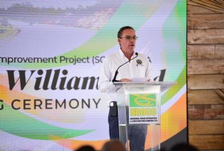 Minister of Science, Energy, Telecommunications and Transport, Hon. Daryl Vaz, addresses the opening ceremony of SCHIP Part A (May Pen to Williamsfield) on September 14.