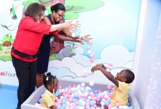 Digicel Foundation Chair, Jean Lowrie-Chin (left), and Chair, Early Childhood Commission (ECC), Trisha Williams-Singh (second left), enjoy play time with students at the Jamaica China Goodwill Infant School in St. Thomas, Amanda McKay (third left) and Travon Shaw, inside a new inclusive classroom at the institution. The space was handed over on Tuesday (September 19).