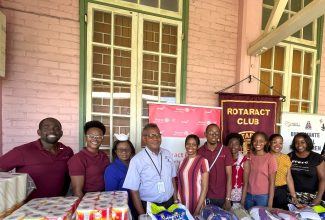 President of the Rotaract Club of Kingston (RCOK), Natasha Burnett (left), along with Director of Nursing Services at the Bustamante Hospital for Children (BHC), Beverly Senior-Berry (third left)), Chief Executive Officer of the hospital, Anthony Wood (fourth left), and other members of the Club at the recent handover of  care items by the Club to the  hospital, in St. Andrew.