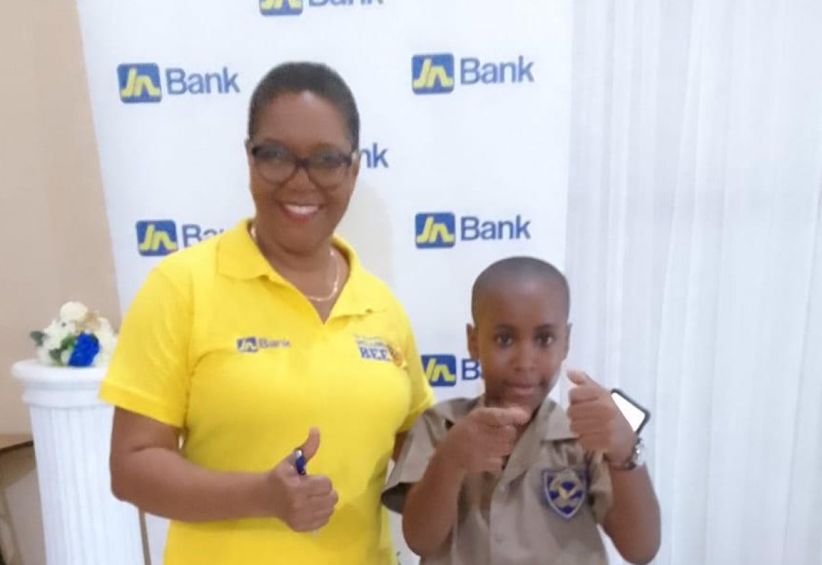Portland’s spelling bee champion, Dayton Jennings, shares a moment with Spell Mistress Marlene Stephenson Dalley, at the competition in Port Antonio on September 26.