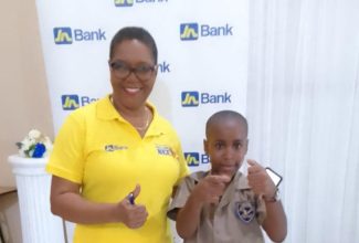 Portland’s spelling bee champion, Dayton Jennings, shares a moment with Spell Mistress Marlene Stephenson Dalley, at the competition in Port Antonio on September 26.

