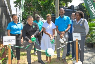 Minister without Portfolio in the Ministry of Economic Growth and Job Creation, Senator the Hon. Matthew Samuda (second left); State Minister in the Ministry of National Security and St. Andrew West Rural Member of Parliament, Hon. Juliet Cuthbert Flynn (centre); and Chief Executive Officer (CEO) for the Forestry Department and Conservator of Forests, Ainsley Henry (second right), cut the ribbon symbolising the commissioning of the upgraded irrigation systems at the agency’s Mount Airy nursery on Tuesday (August 29). Sharing the moment are CEO and Co-Founder of Instant Save Conservation Solutions Limited, Leanne Spence (left), and National Water Commission Acting Vice President of Operations, Dr. Phillipa Campbell-Francis.
