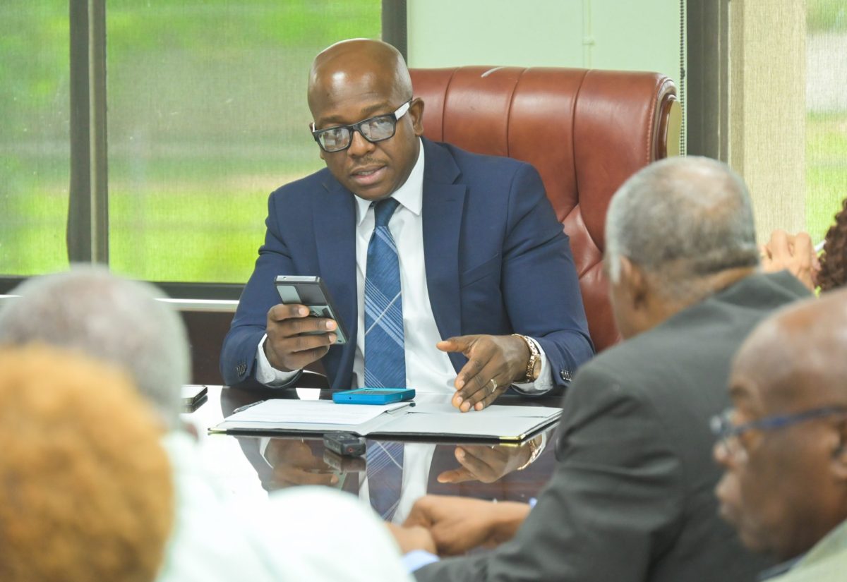 Minister of Labour and Social Security, Hon. Pearnel Charles Jr. (left), meets with Executives of the Jamaica Government Pensioners Association, during a courtesy call at the Ministry’s North Street offices in Kingston, on September 6.