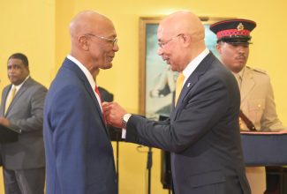 Governor-General, His Excellency the Most Hon. Sir Patrick Allen (right), presents Senior Production Coordinator at the Television Department at the Jamaica Information Service (JIS), Seaton Richards, with the Medal of Honour during a ceremony on Thursday (September 28) at King’s House. Mr. Richards was among persons recognised for outstanding service to the G-G’s office during the tenure of the current Head of State.

