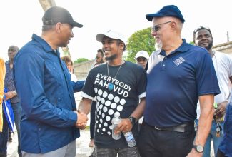 Prime Minister, the Most Hon. Andrew Holness (left), greets participant in the Project STAR (Social Transformation and Renewal)  initiative, Akeem Tate, during a tour of Parade Gardens in downtown Kingston on Friday (September 15). Mr. Holness is accompanied by Project STAR Co-Chair and Sponsor, Keith Duncan.