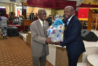 Minister of Labour and Social Security, Hon. Pearnel Charles Jr. (right), presents a gift package to member of Power of Faith Ministries International Incorporated, in Portmore, St. Catherine, 81-year-old Alphonso Fernandez, one of the church’s oldest members. Occasion was Sunday’s (September 17) National Church Service commemorating Senior Citizens Month, which is being observed from September 17 to October 8, under the theme ‘Embracing Wisdom, Uniting Generations’.


