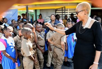 Minister of Education and Youth, Hon. Fayval Williams (right), greets students, parents and teachers during her visit to the Mountain View Primary and Infant School, for the start of the 2023/24 school year, on Monday, September 4.

