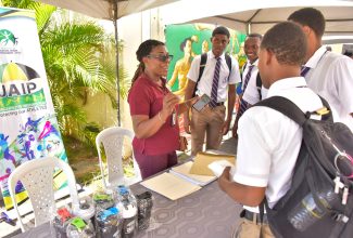 Administrator of the Jamaica Athletes Insurance Plan, Michelle Napier (left), addresses students attending the Jamaica Anti-Doping Commission(JADCO) health and wellness fair held on Friday (September 22), at the agency’s offices on Ballater Avenue in St. Andrew. The fair was part of activities to observe JADCO’s 15th anniversary this year, under the theme ‘Protecting Brand Jamaica Through Clean Sport’.