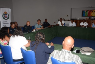 Deputy Prime Minister and Minister of National Security, Hon. Dr. Horace Chang (centre), addresses members of the Negril Chamber of Commerce at Couples Swept Away on Thursday (September 7). He is flanked by Police Commissioner, Major General Antony Anderson, and other personnel from the Jamaica Constabulary Force High Command.