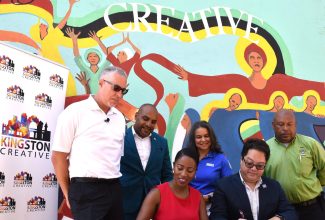 Kingston Creative Executive Director, Andrea Dempster-Chung (seated left), and Expedia Group Senior Business Development Manager, Warren Ho (seated right), affix their signatures to an agreement that will facilitate Jamaica’s participation in Expedia Group’s Sustainability Giveback programme, on Wednesday (September 13) on Water Lane in Kingston. Observing the signing (from left) are Jamaica Tourist Board (JTB) Acting Deputy Director of Tourism for the Americas, Philip Rose; Chief Executive Officer of the Kingston and St. Andrew Municipal Corporation, Robert Hill; JTB Manager of Tour Operators and Airlines, Francine Carter Henry; and Deputy Mayor of Kingston and St. Andrew, Winston Ennis. Kingston Creative received a donation of US$15,000 from the Expedia Group in association with the Jamaica Tourist Board (JTB). Kingston Creative was selected, on the recommendation of the JTB, to be awarded the Expedia Sustainability Grant for 2023 to support its work in community tourism and the wider cultural and creative industries.