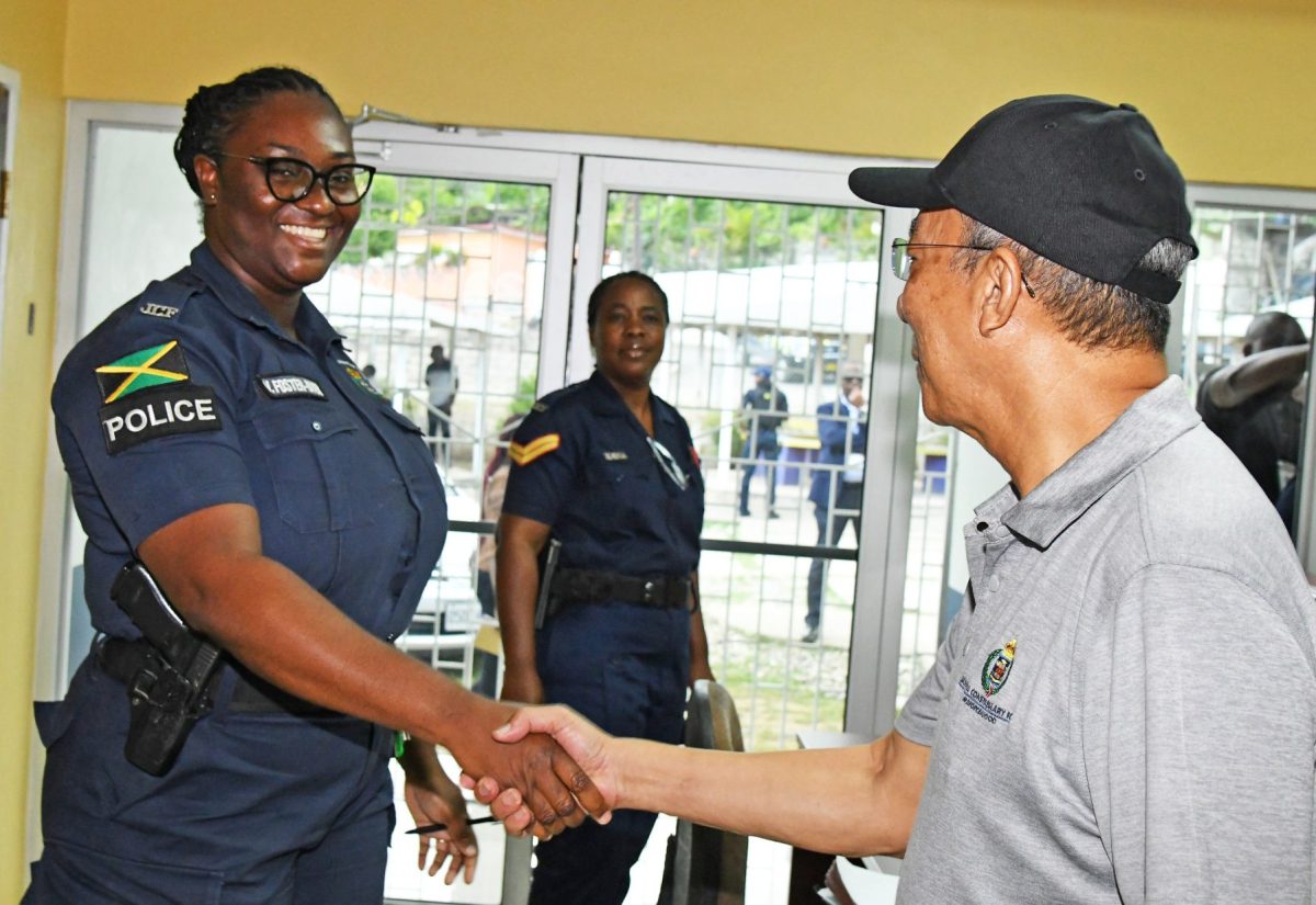 Deputy Prime Minister and Miniter of National Security, Hon. Dr. Horace Chang (right), greets officers attached to the temporarily relocated Bull Bay Police Station on Gems Crescent in St. Andrew, while touring the facility on Friday (September 15). From left are Woman Constable Victorine Foster Dyer and Woman Corporal Janice Rookwood.