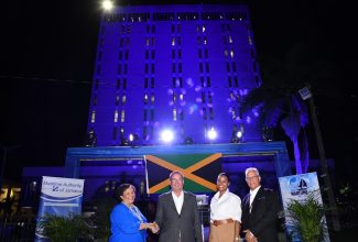 Minister of Science, Energy, Telecommunications and Transport,  Hon. Daryl Vaz (second left), with (from left) Chair of the Maritime Authority of Jamaica (MAJ), Corah Ann Robertson Sylvester; Senior Director, Transport Policy (International and Land) at the Ministry, Tanya Bedward; and Director General of the MAJ, Rear Admiral Peter Brady. Occasion was the MAJ Office Centre Building illumination ceremony to commemorate World Maritime Day 2023, at the MAJ offices in downtown Kingston on September 28.