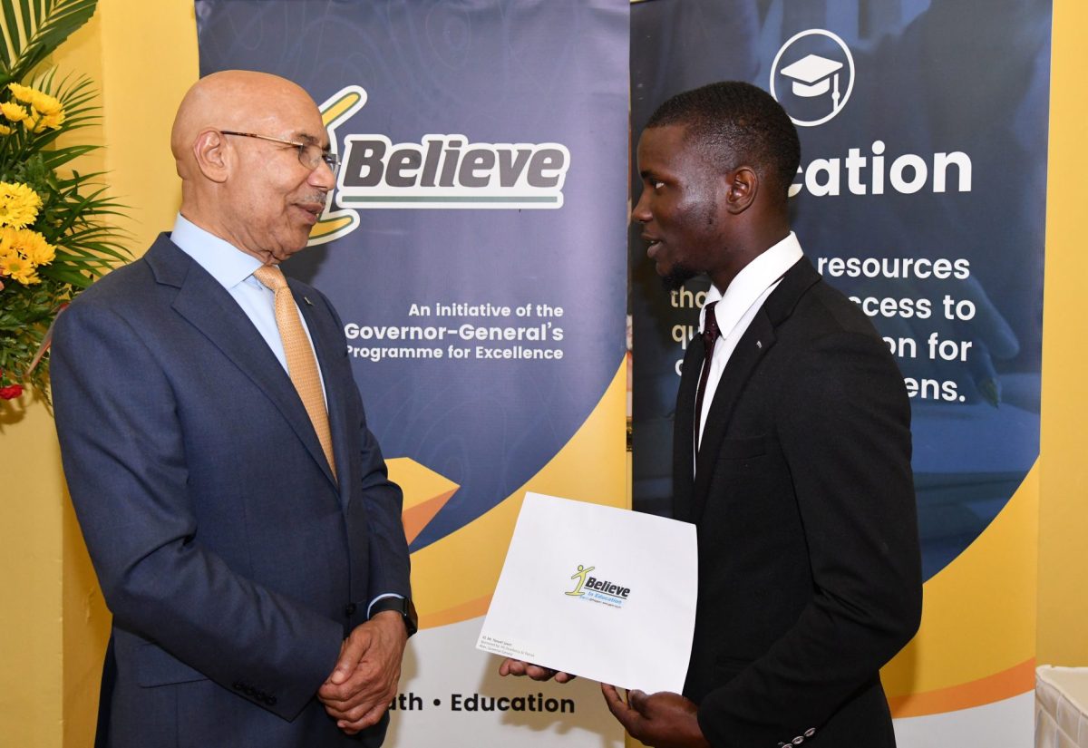 Governor-General, His Excellency the Most Hon. Sir Patrick Allen (left), converses with 2023 Summer of Service (SOS) recipient, Nowell Lewin Jr. (right), during the scholarship presentation ceremony held at King’s House on August 31.