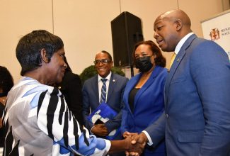 Minister of Labour and Social Security, Hon. Pearnel Charles Jr. (right), greets senior citizen advocate Winnie Anderson-Brown (left) at the launch of Senior Citizens Week, held at the AC Mariott Hotel in New Kingston, today (September 19). Observing (from second left) are Minister of State in the Ministry, Dr. the Hon. Norman Dunn, and Chief Technical Director at the Ministry, Audrey Deer-Williams.