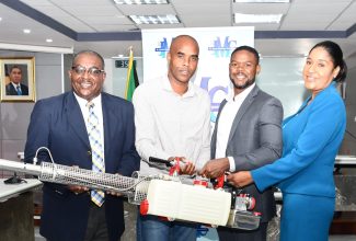 Deputy Mayor of Montego Bay, Councillor Richard Vernon (second right), hands over one of five fogging machines to Parish Manager at the St. James Public Health Department, Lennox Wallace (left) during a ceremony held at the St. James Municipal Corporation offices in Montego Bay on Monday (September 25). The corporation donated the machines to the department to bolster the fight against dengue fever in the parish. Sharing in the moment are Regional Operations Manager at WPM Waste Management Ltd., Edward Muir (second left) and Chief Executive Officer of the St. James Municipal Corporation, Naudia Crosskill.

 

 