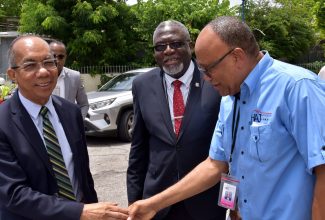 Deputy Prime Minister and Minister of National Security, Hon. Dr. Horace Chang (left), is greeted by Chairman, Board of Directors, Housing Agency of Jamaica (HAJ), Norman Brown (right), at the agency’s Open Day, held at its head office on Caledonia Avenue in St. Andrew, on September 6. At centre is Custos of St. James and Senior Pastor, Faith Temple Assembly of God, Bishop Conrad Pitkin.